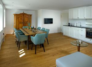 a kitchen and dining room with a table and chairs at Waldach Villa in Thalgau