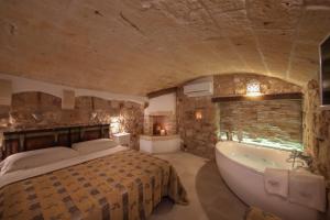a bedroom with a bed and a bath tub at HolidayMonopoli in Monopoli