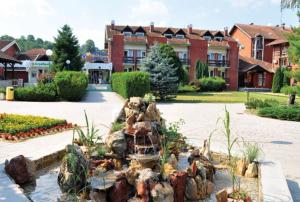 a water fountain in front of a building at Apartmani Centar Banja Vrujci in Mionica