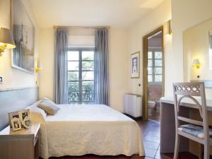 Postel nebo postele na pokoji v ubytování Hotel Mignon