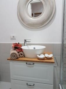 a bathroom with a sink and a mirror at Affitta Camere da Nonna Maria in Lesina
