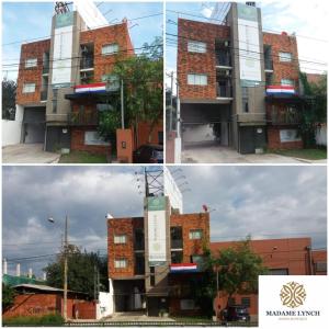 a building with a sign in front of it at Madame Lynch Hotel Asuncion in Asunción