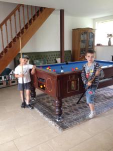 two young boys standing next to a pool table at Self Catering for large groups, friends/families in Romagny