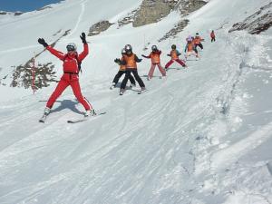a group of people skiing down a snow covered slope at Haus Valentin in Heiligenblut