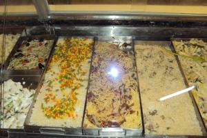 a display case with many different types of food at Habitaciones Florencia in La Serena