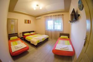 a room with two beds and a window at Apartments Ratkovic in Trebinje +29 photos
