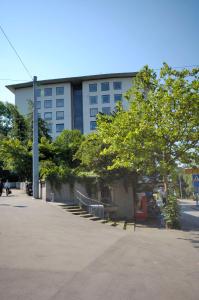 a large building with stairs and trees in front of it at Nice studio in the city center - Vineyard 22 in Zürich