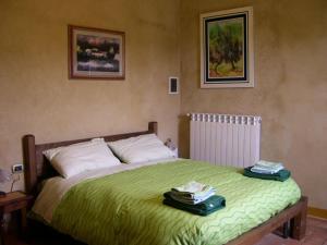 a bedroom with a bed with two towels on it at Borghetto Di San Filippo in Barberino di Val dʼElsa