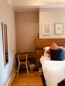 a bedroom with a bed and a desk and a chair at Maritime Pods in Portsmouth