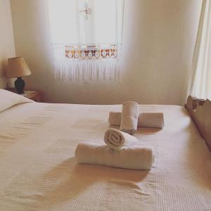 a bedroom with towels on a bed with a window at The "M" House in Gaios +14 photos