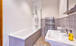 a bathroom with two sinks and a shower and a tub at Highfield House in Ambleside +15 photos