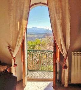 an open door to a balcony with a view at Casa Di Castello in Castelmuzio