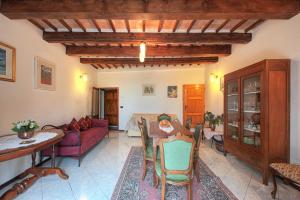 a living room with a couch and a table at Casa Di Castello in Castelmuzio +12 photos