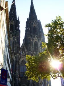 eine große Kathedrale mit einem Baum davor in der Unterkunft Apartment Cologne City in Köln