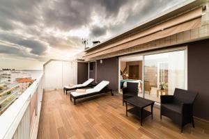 a balcony with furniture and a view of the city at Hôtel Hélios in Juan-les-Pins