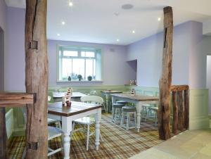 a dining room with wooden tables and chairs at 1885 the Venue - Pub, Restaurant, Rooms & Function House in Halifax +22 photos