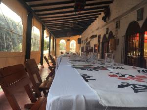 a long table with a white table cloth on it at Hotel Rural La Esperanza in Suesca +79 photos