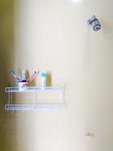 a shelf with toothbrushes and other bathroom items on it at Srikaloka 12 Kostel - for Female and Couple in Yogyakarta