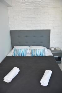 a bedroom with a large bed with two pillows on it at Princess Luxury Suite in Paralia Katerinis +38 photos