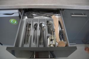 a drawer filled with utensils in a kitchen at Princess Luxury Suite in Paralia Katerinis
