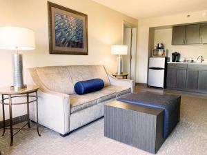 a living room with a couch and a kitchen at Holiday Inn University Area Charlottesville, an IHG Hotel in Charlottesville