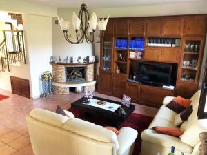 a living room with a couch and a fireplace at Stunning Sicilian Villa in Carini