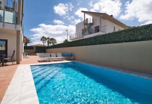 a swimming pool in front of a house at Casa de Marina in San Miguel de Abona