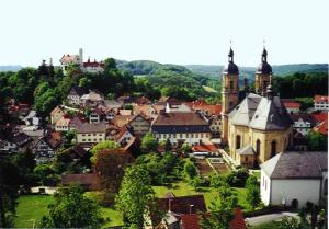 a small town with a church and a city at Hotel Krone in Gößweinstein