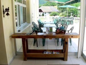 a wooden table with chairs on a patio at Résidence Florimontane in Talloires