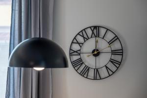 a clock on a wall next to a window at Midnight Blue in Burgas