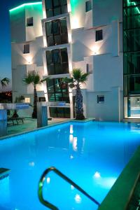 a hotel swimming pool in front of a building at Boutique Residence Cosmopolis 1 in Bibinje