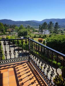 a balcony with a black railing and a view at Villa Pazos in Nigrán