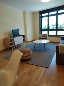 a living room with a couch and a table at Iacobus VUT-CO-00371O in Padrón