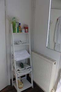 a shelf with towels and a mirror in a room at Walmer House in Deal