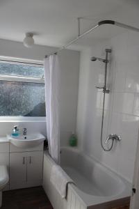 a bathroom with a tub and a sink and a shower at Walmer House in Deal