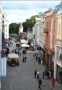 a group of people walking down a street at Viru Backpackers Hostel in Tallinn