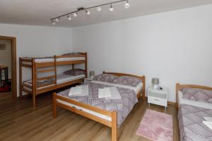 a bedroom with two bunk beds and a couch at Prenoćište Kastel in Knin