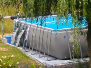 a swimming pool with a row of chairs in it at Ferienwohnung Cillien in Dudeldorf