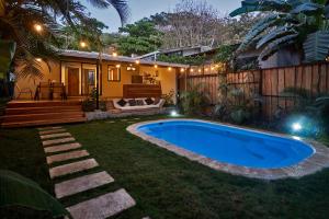 a swimming pool in the yard of a house at Villa Flamingo in Santa Teresa Beach