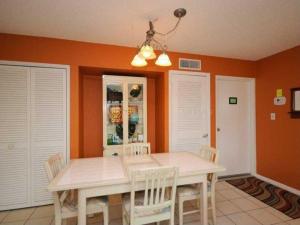 a dining room with a white table and chairs at Crescent Arms Condominiums in Siesta Key