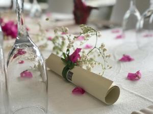 a table with a glass bottle and flowers on it at Villas Sin Sin in Canggu