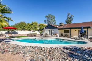 a swimming pool in front of a house at Bell Villa - Resort Living - Pool - Location - Events in Phoenix