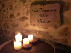 a candle is lit next to a table with candles at Casa Vacanze Le Muse in Pieve Fosciana