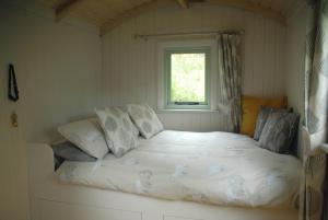 a bed in a room with a window at Howe of Torbeg in Ballater