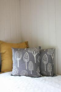 a pillow with trees on it sitting on a bed at Howe of Torbeg in Ballater