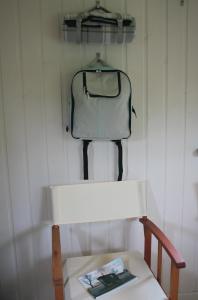 a bag hanging on a wall next to a chair at Howe of Torbeg in Ballater