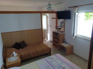 a small room with a bed and a desk at Apartments Bajo - FREE PARKING in Dubrovnik