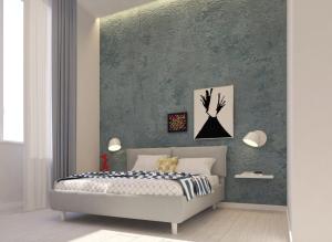 1 dormitorio con cama y pared verde en N'Agorà B&B, en Nápoles