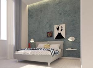 a bedroom with a bed and a green wall at N'Agorà B&B in Naples