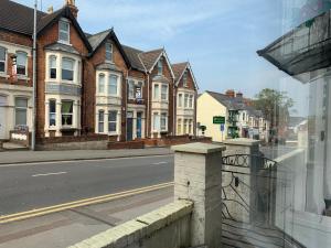 a row of houses on a city street at Swandown Hotel in Swindon